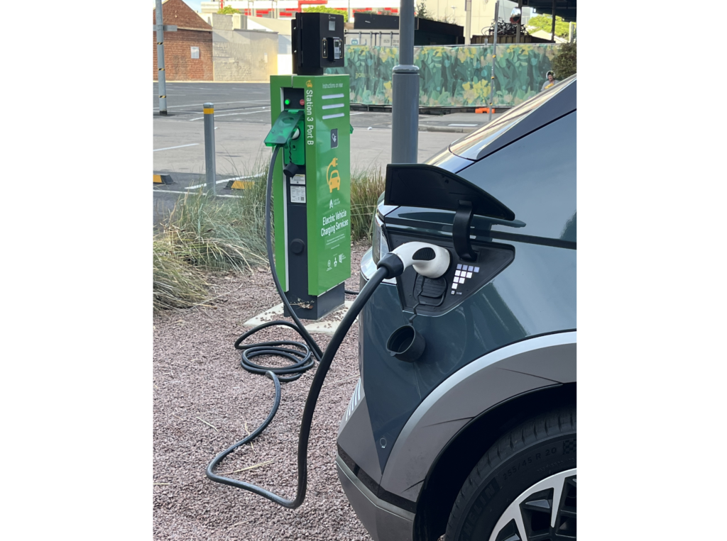 EV Photo of electric vehicle at charging station.